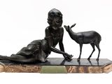 bronze statue of a woman and a deer on a marble base