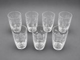 six shot glasses sitting on top of a table next to each other