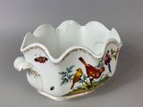 a white bowl with birds and flowers on it