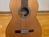 an acoustic guitar sitting on top of a hard wood floor