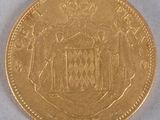 a close up of a gold coin with a crown on it