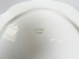 underside view of a white porcelain bowl with a white rim