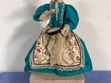 an image of a figurine of a woman sitting on top of a box