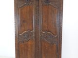 an image of a wooden armoire with carvings on the doors