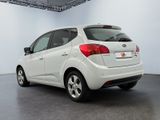 a picture of a white car parked in a showroom