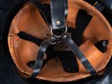 a close up of a helmet with a leather strap