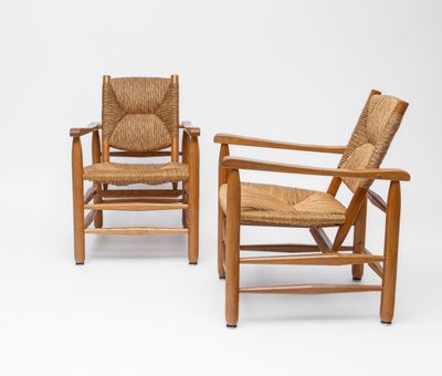two wooden chairs with wicker seats on a white background
