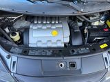 the engine of a car with a yellow button on it ' s hood