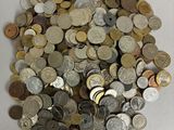 a pile of coins sitting on a white surface