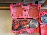 a red tool box with tools in it on the floor