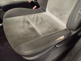 a dirty seat in the back of a car