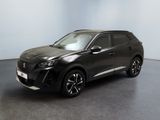Le SUV noir est garé dans une pièce au sol gris.