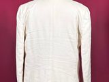a white shirt on a mannequin stand against a red wall