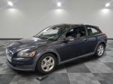 a picture of a blue volvo wagon parked in a garage