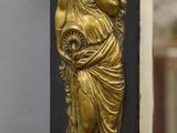 a mirror that has a gold statue on it