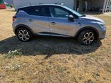 a silver car that is parked in the grass