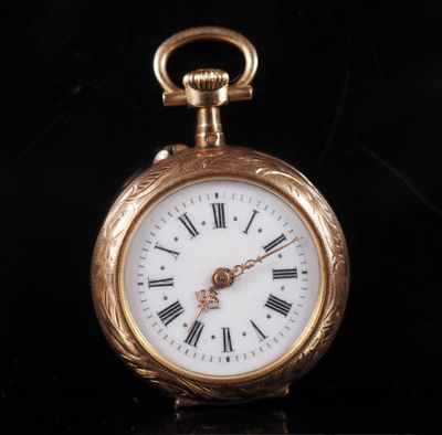 a gold pocket watch with roman numerals on the face