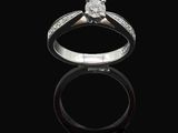 a close up of a diamond ring on a black surface