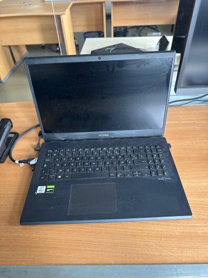 a laptop computer sitting on a desk next to a monitor