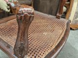 a wooden rocking chair with a cushion on top of it