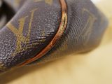 a close up of a louis vuitton bag on a table
