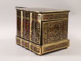 a small wooden table with a gold and black design on it