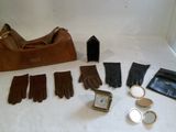 a lot of gloves, a purse, a watch, and other items laid out on a table