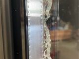 a broken glass window in the middle of a room