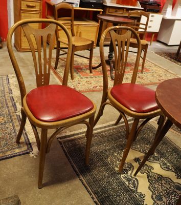 four chairs and a table in a room