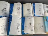 a lot of books with drawings on them on a table