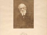 an old photo of a man with a beard and a suit