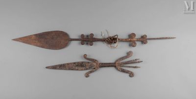 three old metal objects are displayed on a white surface