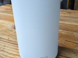 an image of a white air purifier sitting on top of a wooden table
