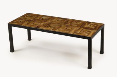 the table is made of wood and metal with a pattern on it