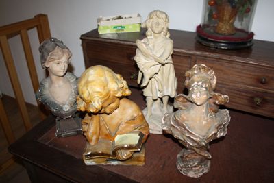 many figurines sitting on a table in a room