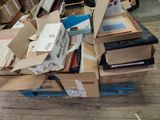 a pile of books on a pallet in a room