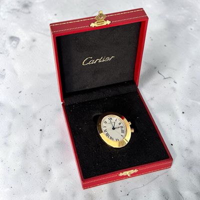a red box with a gold watch inside of it