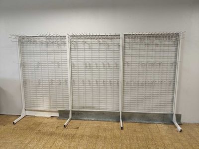 two metal racks with wire on each side of them in a room
