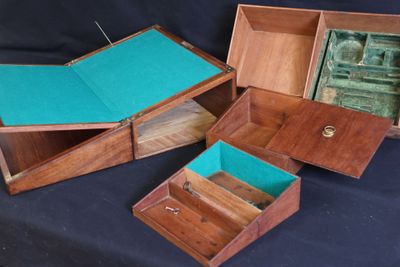 three wooden boxes with a turquoise cover are sitting on a black surface