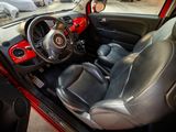 a small red car with a black leather seat and steering wheel