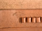 a close up of a brown leather case with a number on it