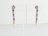 a pair of earrings with pearls and amethorate