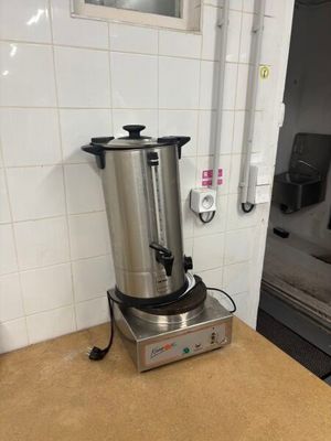 a coffee pot sitting on a counter in a kitchen
