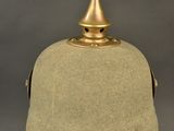 an image of a helmet on a stand against a gray background