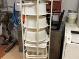 a stack of white dishes on a cart in a kitchen