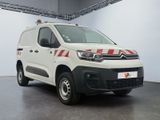 the white van is parked inside of a building with a red and white stripe on the side