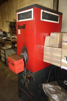 a large red machine that is sitting in a warehouse