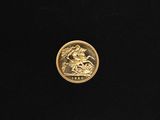a close up of a gold coin on a black surface