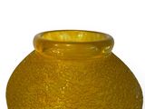 a yellow vase that is sitting on a white surface
