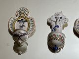 five different types of decorative wall hooks on the wall